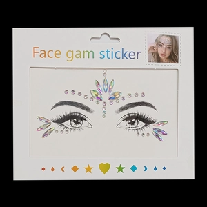 Detailed view of iridescent teardrop face gems for festival makeup on white card
