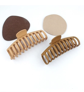 Detail of matte hair claws in brown and tan with matching color swatches