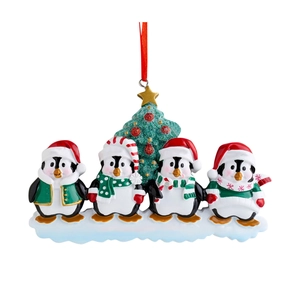 Christmas penguin family ornament with four penguins and a festive green sequin tree
