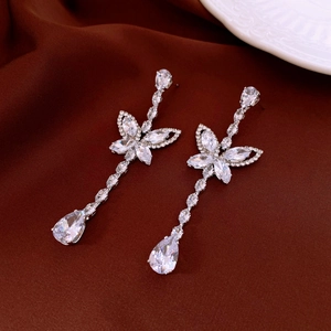 Detail view of silver zircon butterfly earrings with elegant teardrop pendant dangles
