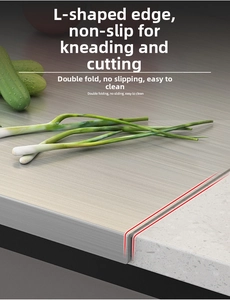 Close-up of L-shaped stainless steel pastry board with non-slip edge on kitchen counter