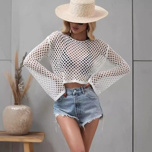 White crochet knit long sleeve crop top with flared sleeves and hollow out design