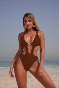 Detail of deep brown cut-out swimsuit with gold U-shaped metal ring and thin straps