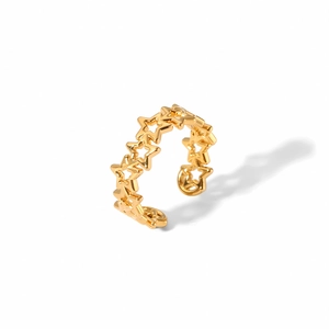 Détail macro de la bague ajustable dorée avec motif d'étoiles évidées et polies