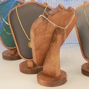 Macro view of natural wood necklace jewelry display stands with clear grain details
