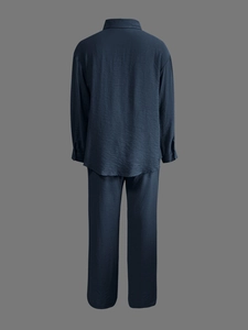 Detail of navy blue long sleeve shirt set showing premium textured draped fabric finish