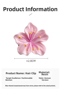 Detail view of a 2.8cm pink resin cherry blossom hair clip with a yellow center