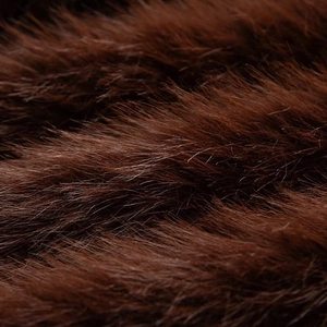 Macro close-up showing the soft texture and glossy fibers of deep brown faux fur fabric