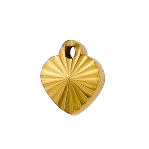 Macro detail of a 18k gold heart pendant with a radiant sunburst textured finish