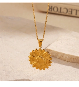 Close-up of a 18K gold-plated sunflower pendant on a stainless steel chain necklace