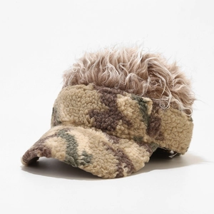 Detailed view of camouflage fleece texture and brown curly synthetic wig on the cap