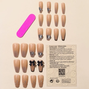 Press-on nail set with coffee gradient, black bows, silver glitter, and heart charms