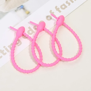 Three rose pink silicone cable ties with non-slip threaded texture for accessories