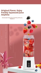 Close-up of portable blender mixing fresh strawberries and ice cubes in a matte cup