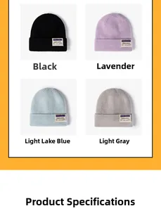 Detail view of four knit beanies in black, purple, blue, and grey with patch labels