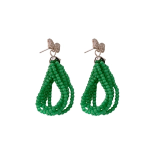 Elegant jewelry set with green seed bead tassel earrings and metallic bow accents