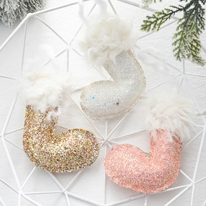 Sparkly Christmas boot ornaments in white gold and pink with fluffy faux fur trim