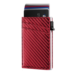 Macro shot of red carbon fiber wallet with automatic pop-up mechanism and credit cards