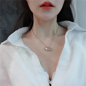Elegant 18k gold plated butterfly necklace with pearl shell wing on a female model