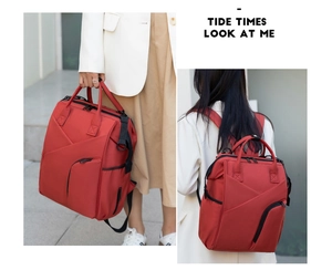 Macro detail of red large mommy bag featuring waterproof fabric and multi-functional straps