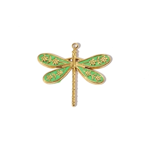 Macro view of dragonfly pendant with gold metal frame and green enamel drip finish