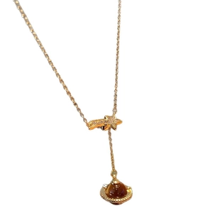 Golden planet pendant necklace with zircon star and brown tiger eye stone on white background