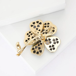 Elegant gold clover brooch with black petals on white stand for women suit accessories