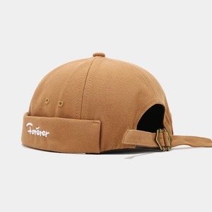 Close-up of Forever embroidery and adjustable metal buckle on brown canvas docker hat