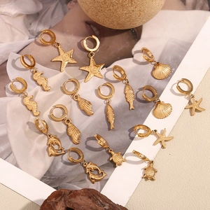 Detail of 18K gold plated stainless steel marine charms featuring starfish and seashell