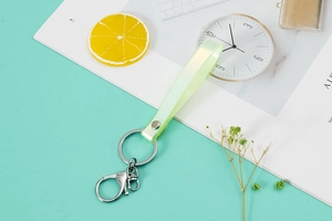 Detail of neon green PVC wristlet strap with silver metal ring and lobster clasp