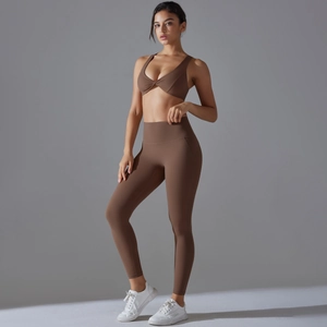 Detail of mocha high-waisted yoga leggings and twist-front sports bra gym set