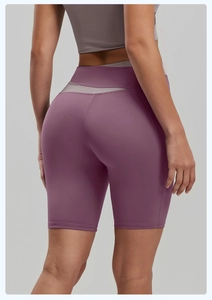 Close-up of ergonomic stitching and lifting seam on purple high-waist yoga shorts