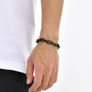 Detail of minimalist black stainless steel square link chain bracelet on a model wrist