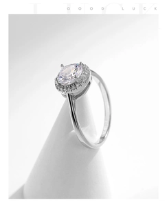 Macro view of an elegant S925 sterling silver ring featuring an oval-cut halo cubic zirconia