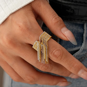 Detailaufnahme des zweifarbigen Quastenrings in Gold und Silber am Finger