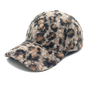 Close-up of leopard print baseball cap showing warm faux lamb wool and fuzzy texture