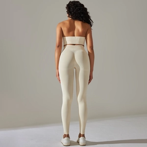 Detail view of the ribbed seamless fabric on back of cream yoga set with leggings