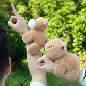 Outdoor shot showing plush capybara snap bracelet worn on wrist with soft brown fur
