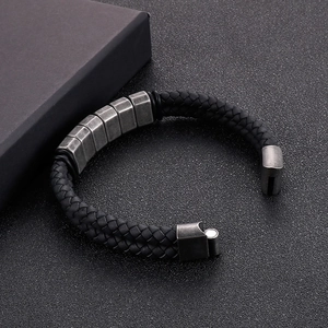Close-up of black braided leather men's bracelet with vintage magnetic steel clasp