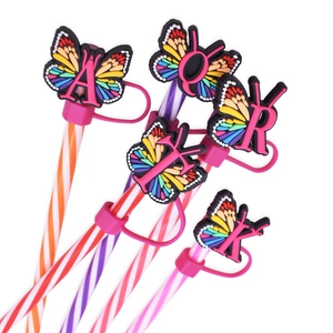 Detailed view of 10mm butterfly alphabet straw covers in vibrant rainbow PVC material