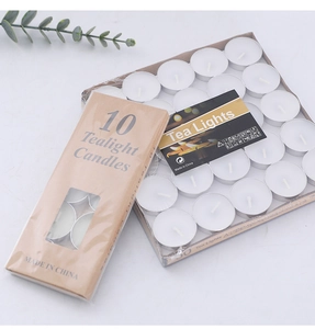 Macro detail of white smokeless tealight candles in aluminum shells with paper packaging