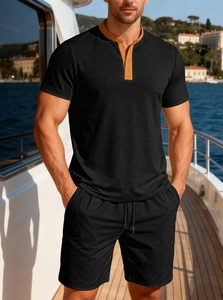 Men's summer black knit two-piece set featuring short sleeves and shorts on a yacht deck