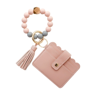 Detail of pink PU leather card holder keychain with silicone beads and gold ring clasp