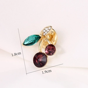 Detailed view of cherry brooch dimensions 1.8cm by 1.9cm with red crystal stones
