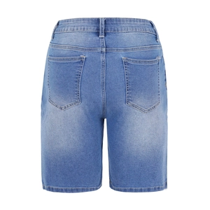 Detail view of the back pockets and washed denim texture of these blue cropped jeans