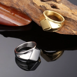 Detail of square signet rings in gold and silver finish with polished mirror surface