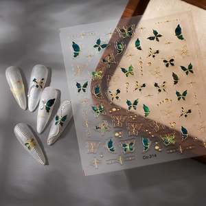 Macro shot of Co-314 butterfly nail stickers with gold relief outlines and green details