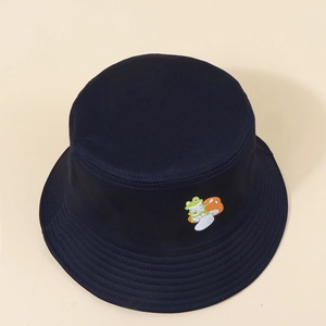 Detail shot of navy bucket hat featuring a colorful frog and mushroom embroidery