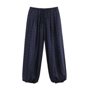 Detail of navy blue plaid casual pants with drawstring waist and elastic cuffs