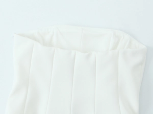 Detail shot of the neckline and fabric texture on a white strapless tube top